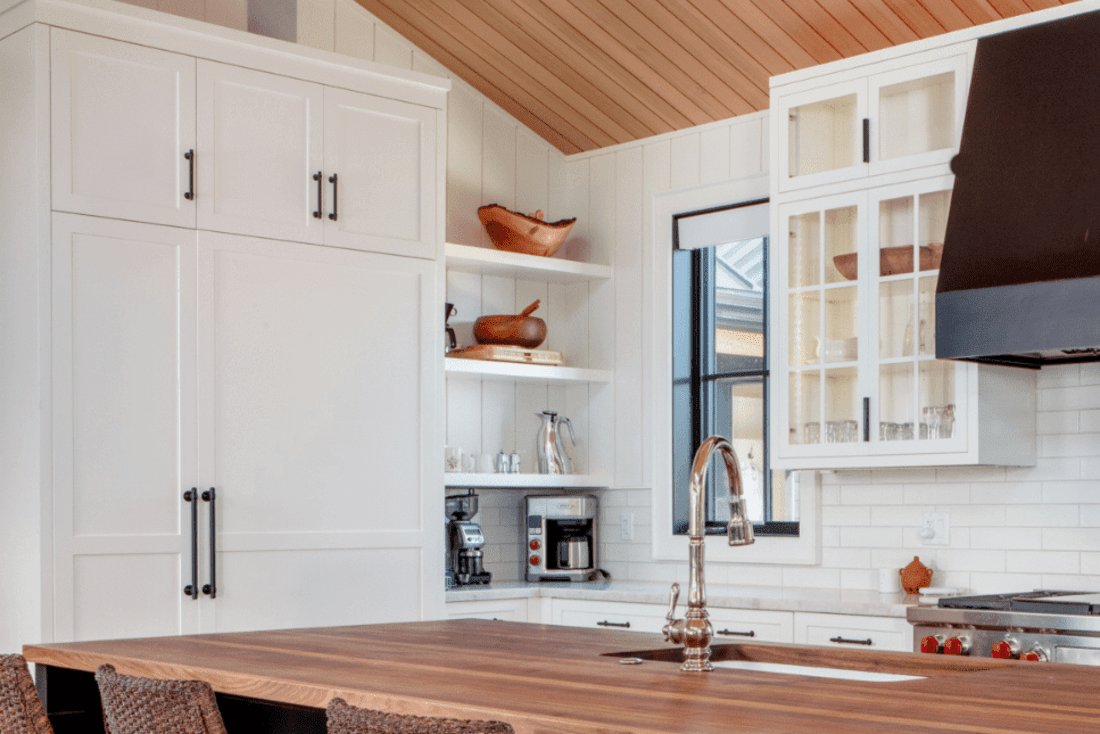 White kitchen cabinets with corner open shelves
