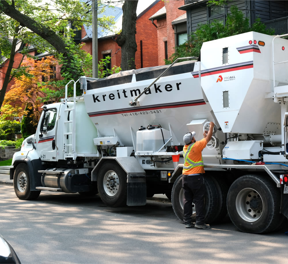 Man with white kreitmaker concrete truck.