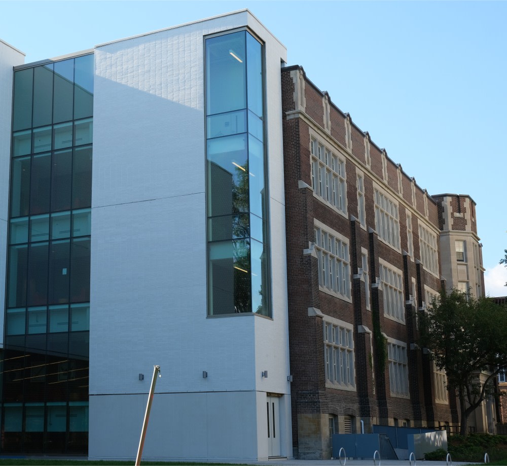 Modern white brick building beside old brown brick building