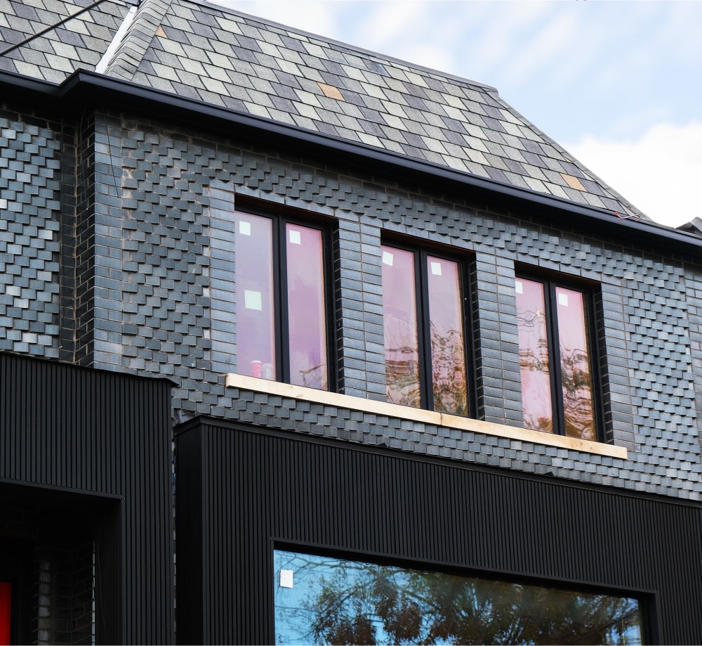 Top floor of residential home with black glazed brick.