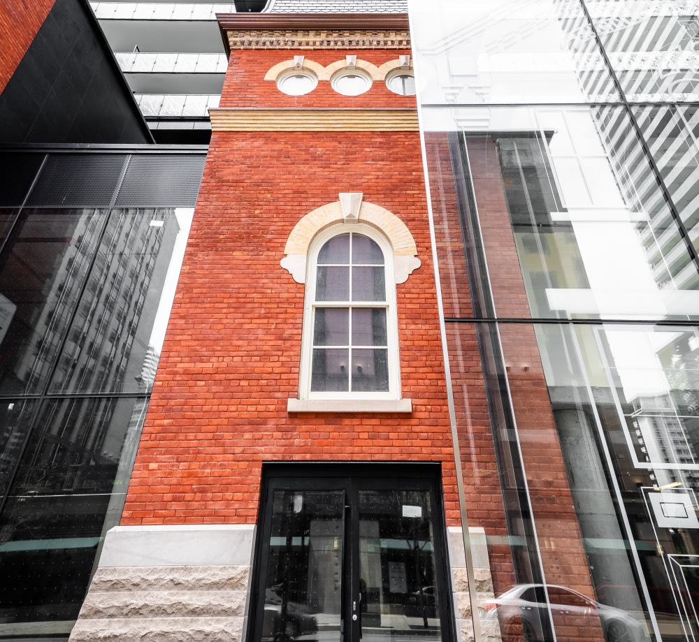 Base of red brick clock tower.