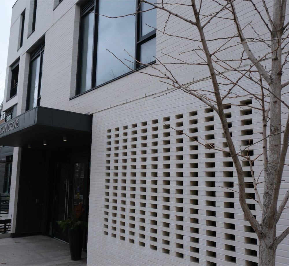 Grey patterned brick on exterior wall of a condo building.