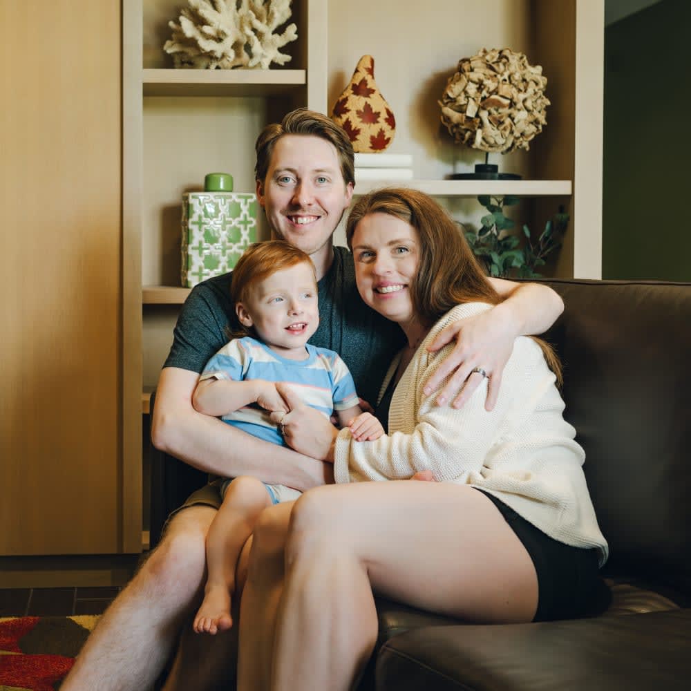 Mom, dad, toddler boy on couch