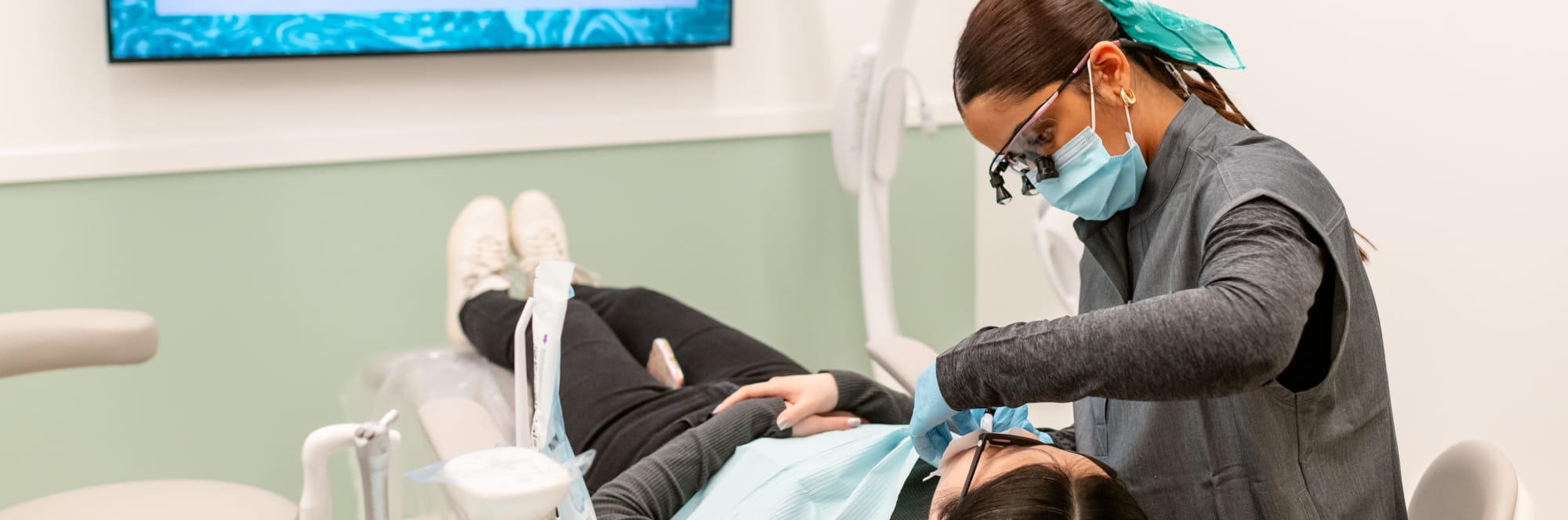 Dental professional performing treatment on a patient.