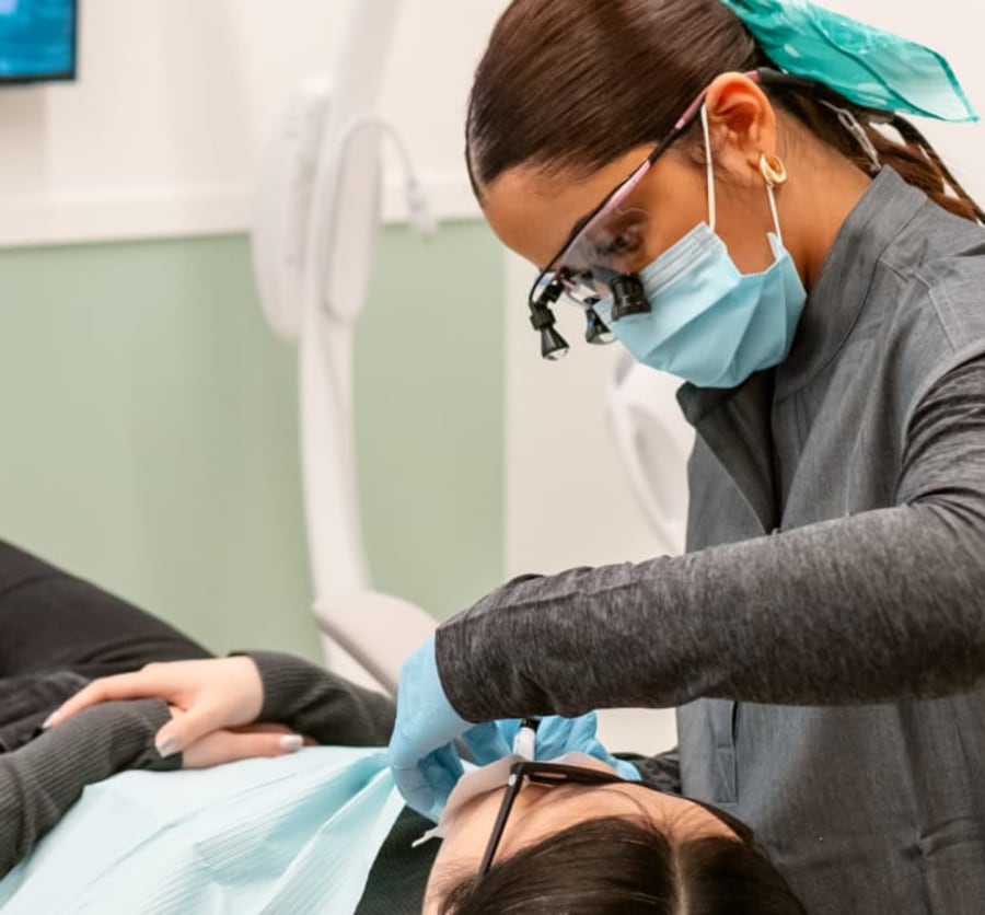 Dental professional performing treatment on a patient.