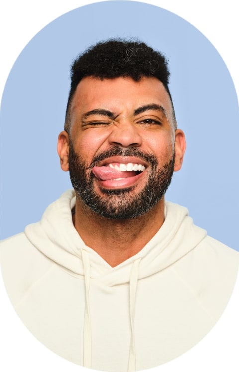 A man is scrunching up his face and sticking his tongue out.