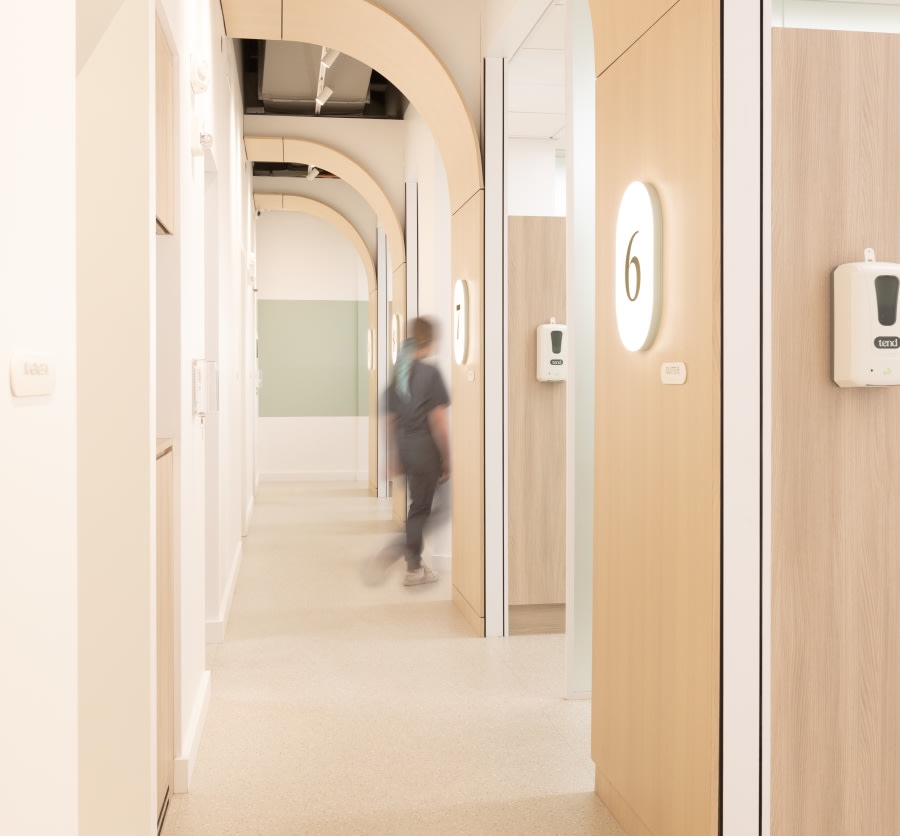 Long hallway with a blurred walking dental professional.