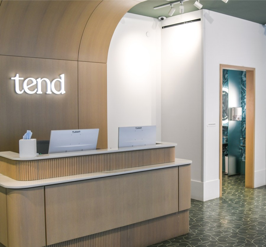 Reception desk in dental studio with open door to brushing area.