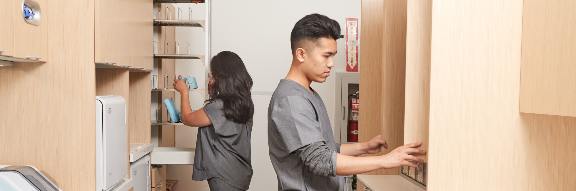 Two team members look through the sterilization area.