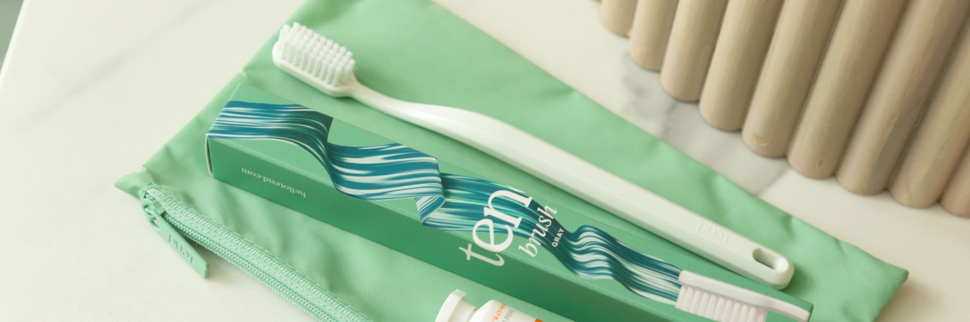 Zippered brush bag with toothbrush and toothpaste.