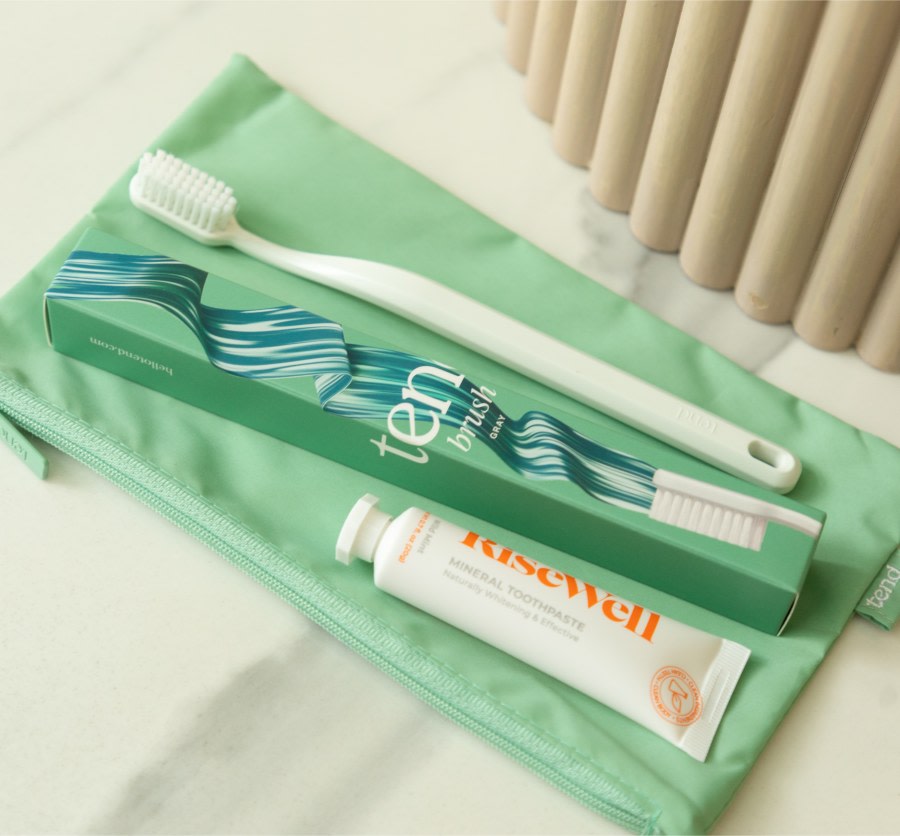 Zippered brush bag with toothbrush and toothpaste.