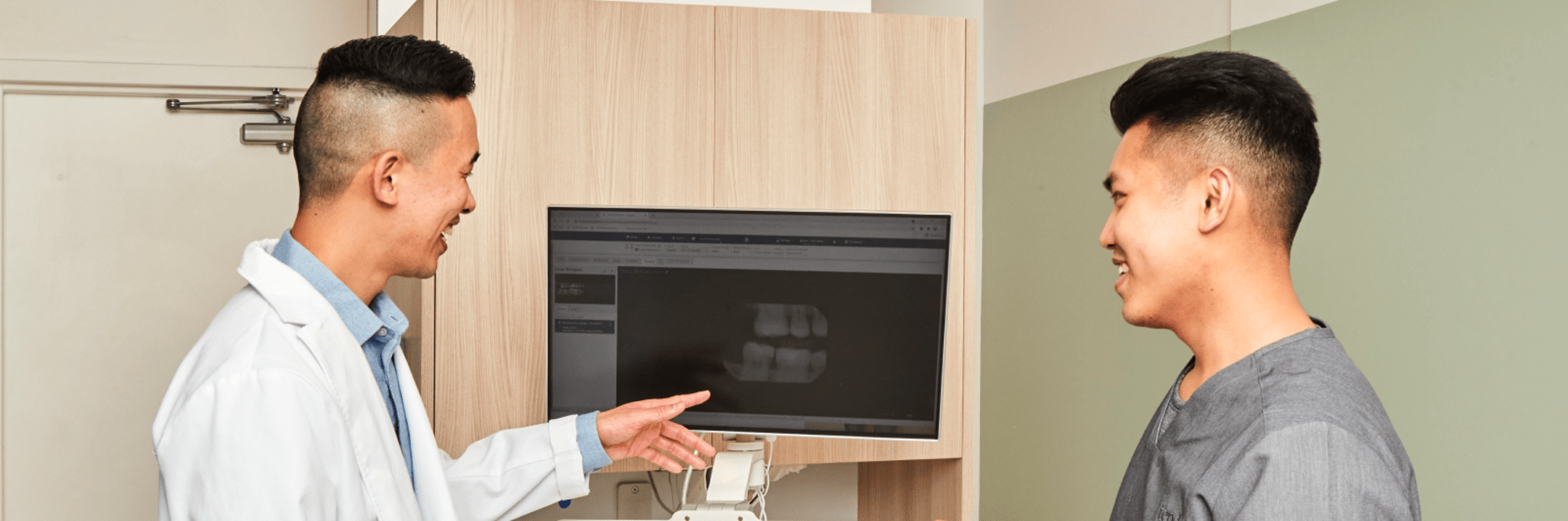 Two team members look at a dental X-ray.