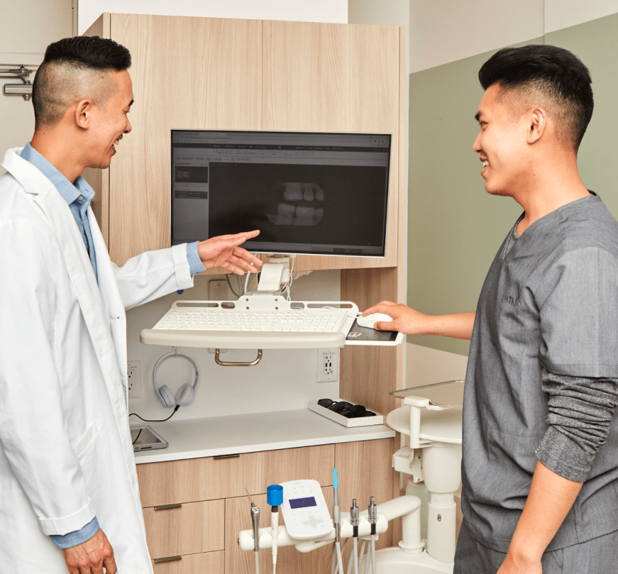 Two team members look at a dental X-ray.