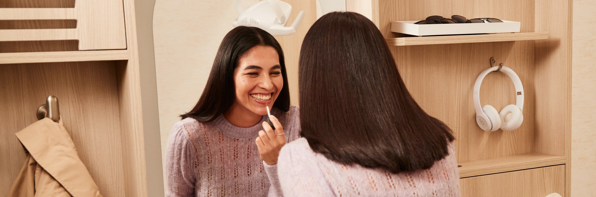 A patient admires her smile in a mirror.