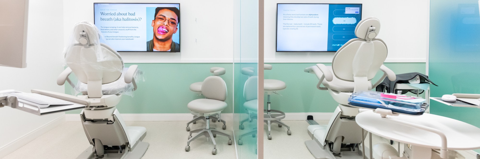 Dental treatment rooms with chairs and TVs.
