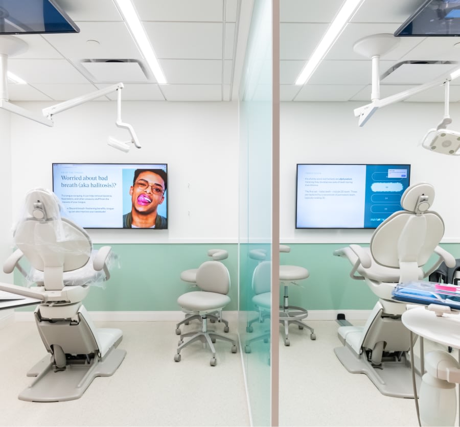 Dental treatment rooms with chairs and TVs.