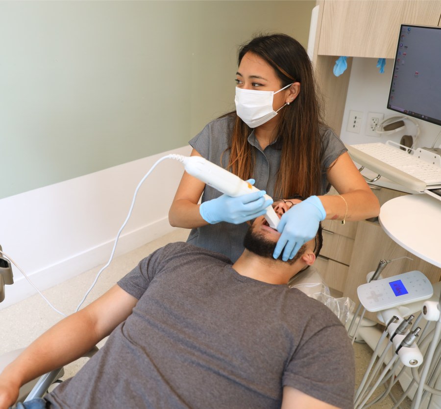 Dental professional performing an intraoral scan on a patient.