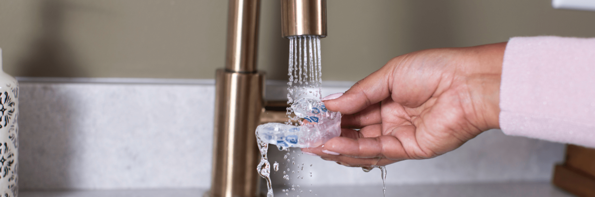 A team member washes a Perio Protect tray.