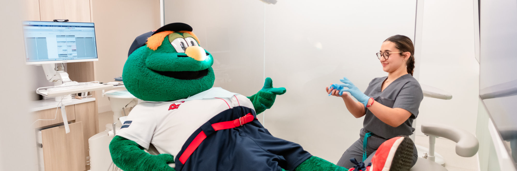 Wally the Green Monster chats with a team member.