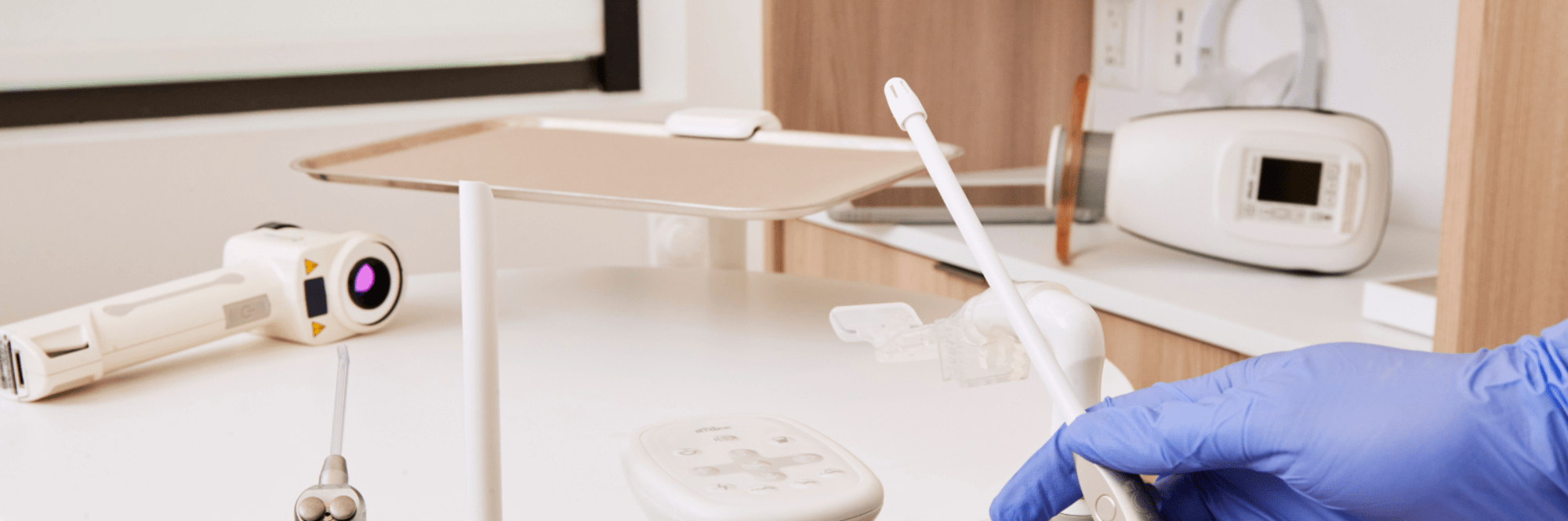 Variety of dental tools with a gloved hand holding a tool.