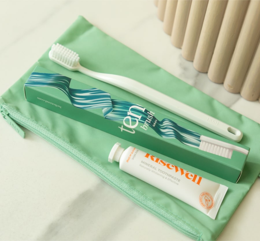 Zippered brush bag with toothbrush and toothpaste.