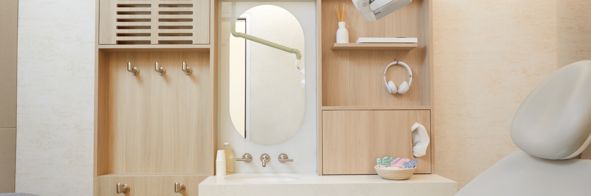 Dental treatment chair with sink, counter, and mirror behind.