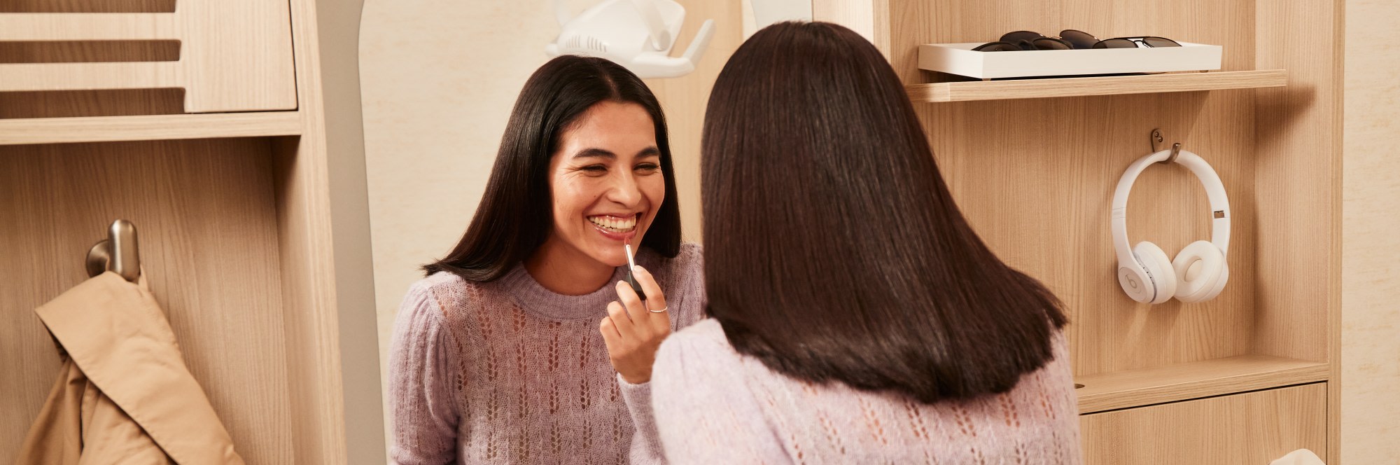 A patient admires their teeth in the mirror.