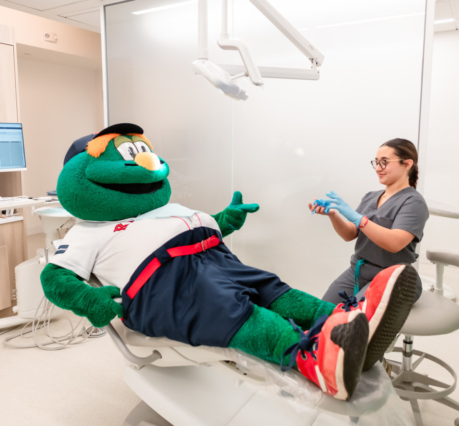Wally the Green Monster chats with a team member.