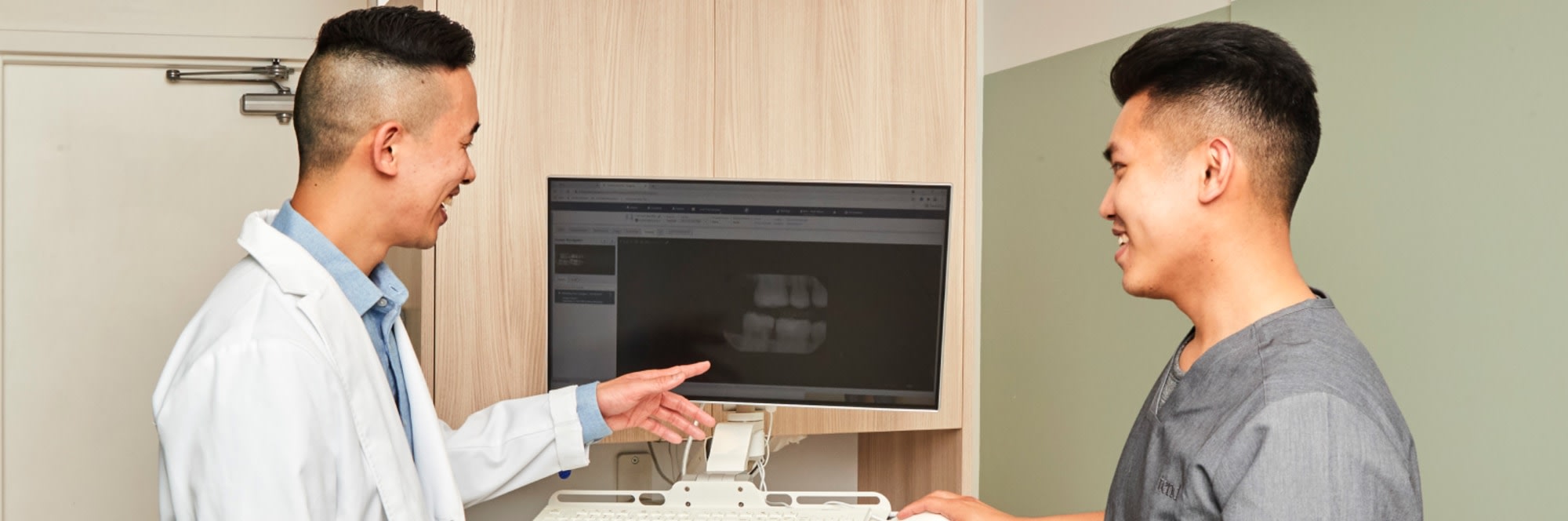 Two team members look at an X-ray.