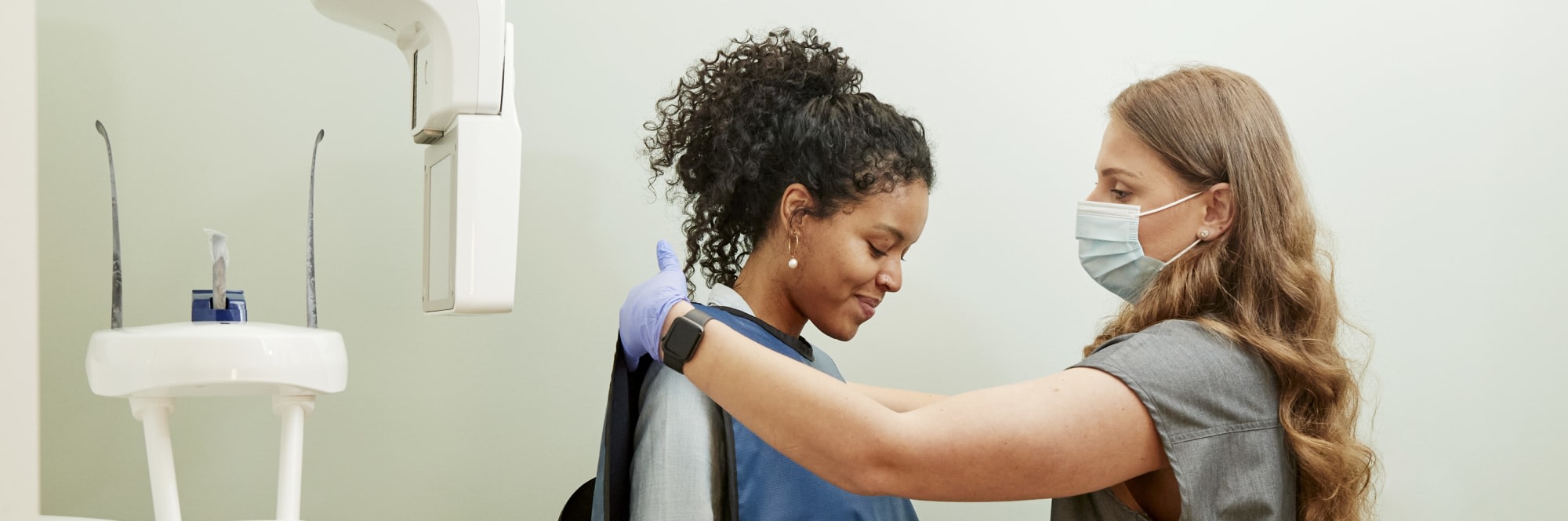A team member preps a patient for an X-ray.