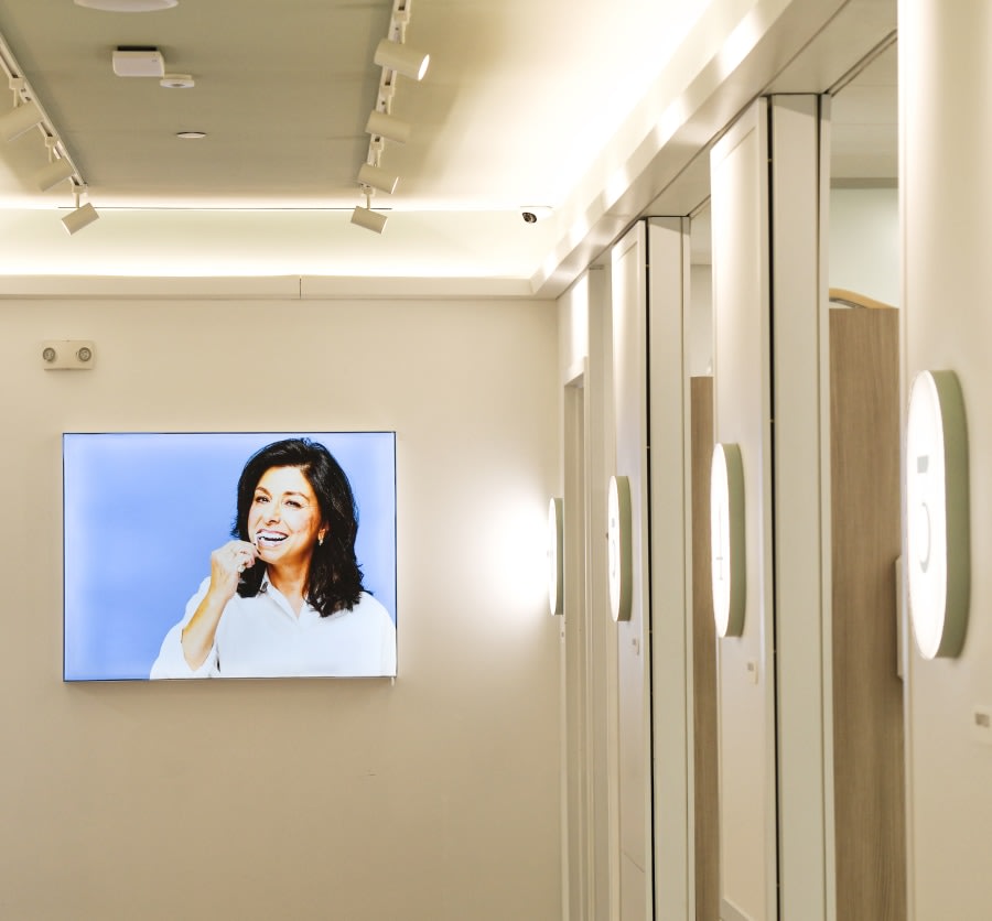 Hallway in dental studio with wall art of woman brushing teeth.