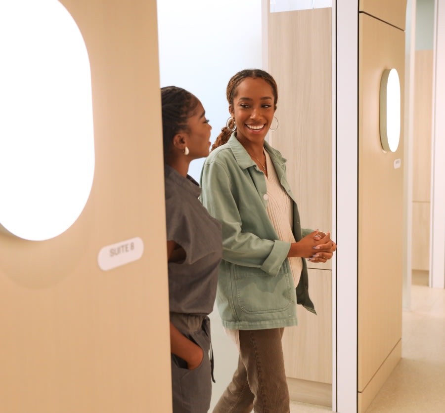 Dental professional and patient step out of treatment room.