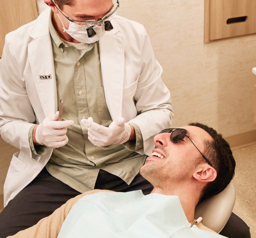 Dental professional performing treatment on a patient.
