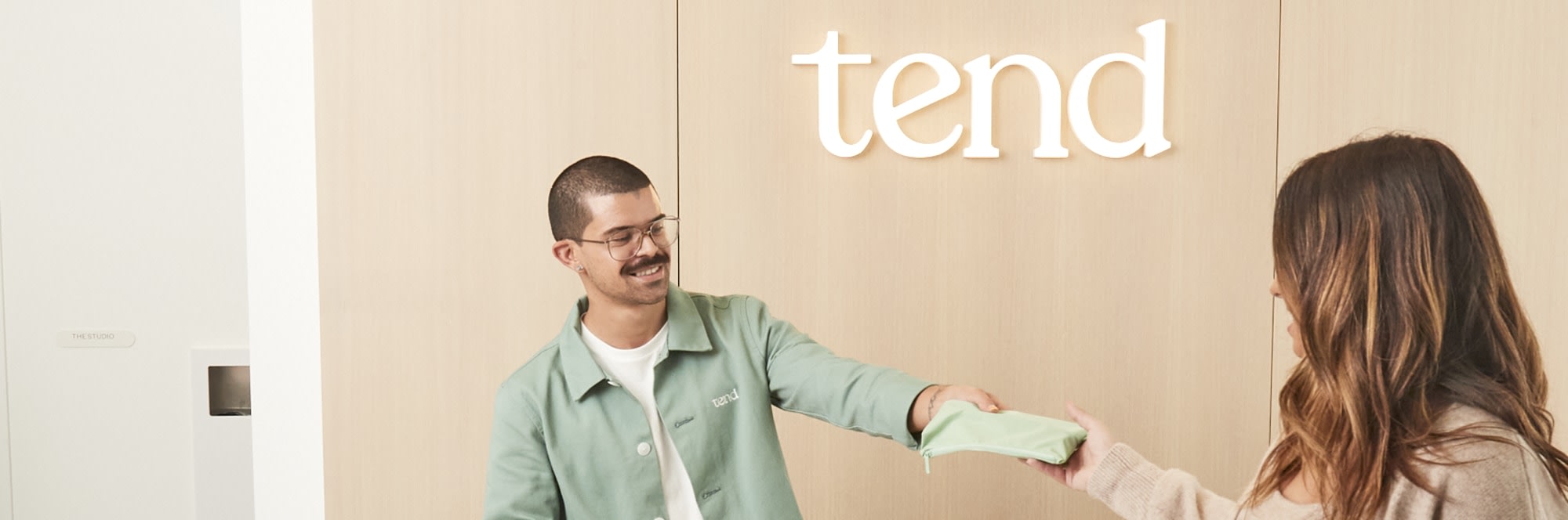 A team member greet a patient at the reception desk.