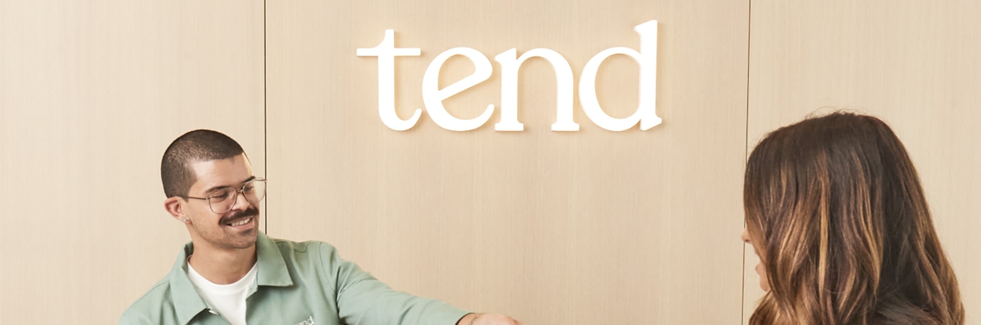 Dental receptionist handing brush bag to patient.