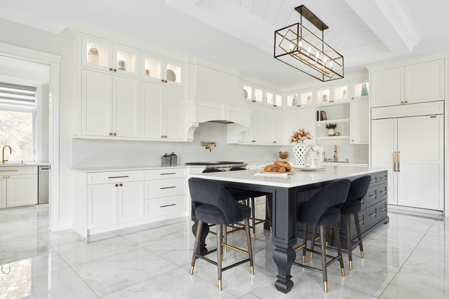White transitional kitchen with black island and gold accents