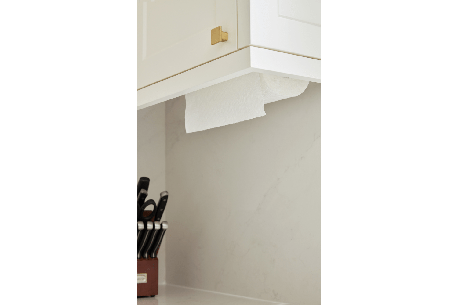 White and gold spice kitchen with hidden paper towel holder