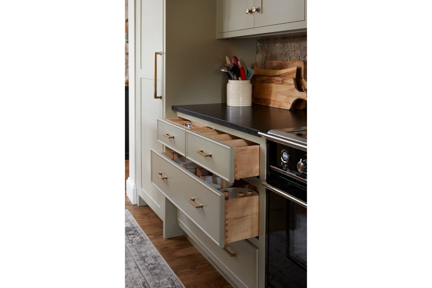 Gray kitchen cabinets with two open dovetail detailed drawers