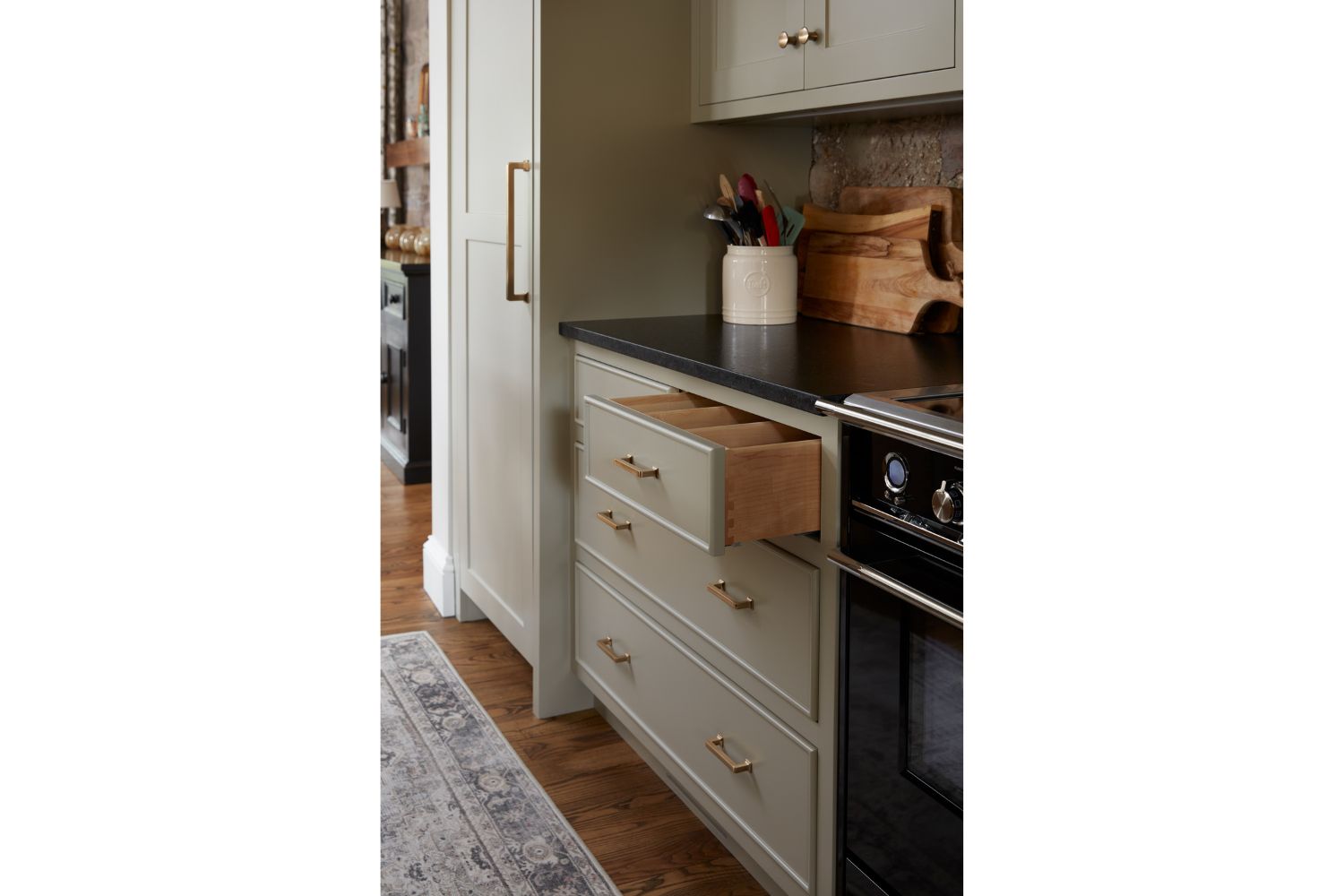 Gray kitchen cabinets with open dovetail detailed drawer