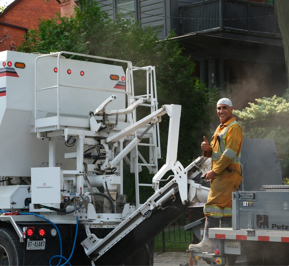 Man in safety outfit operating machinery.