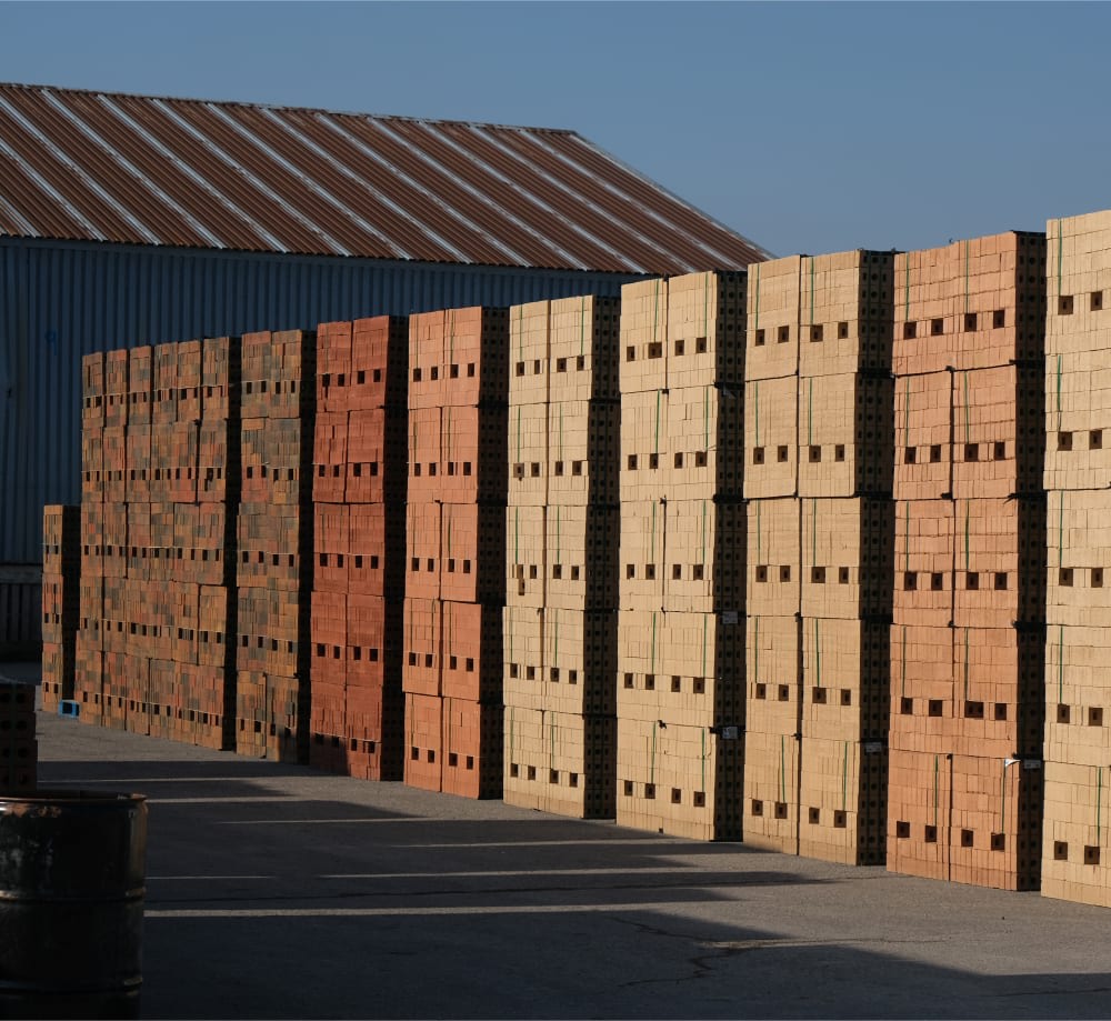 Stacks of bricks in yard.