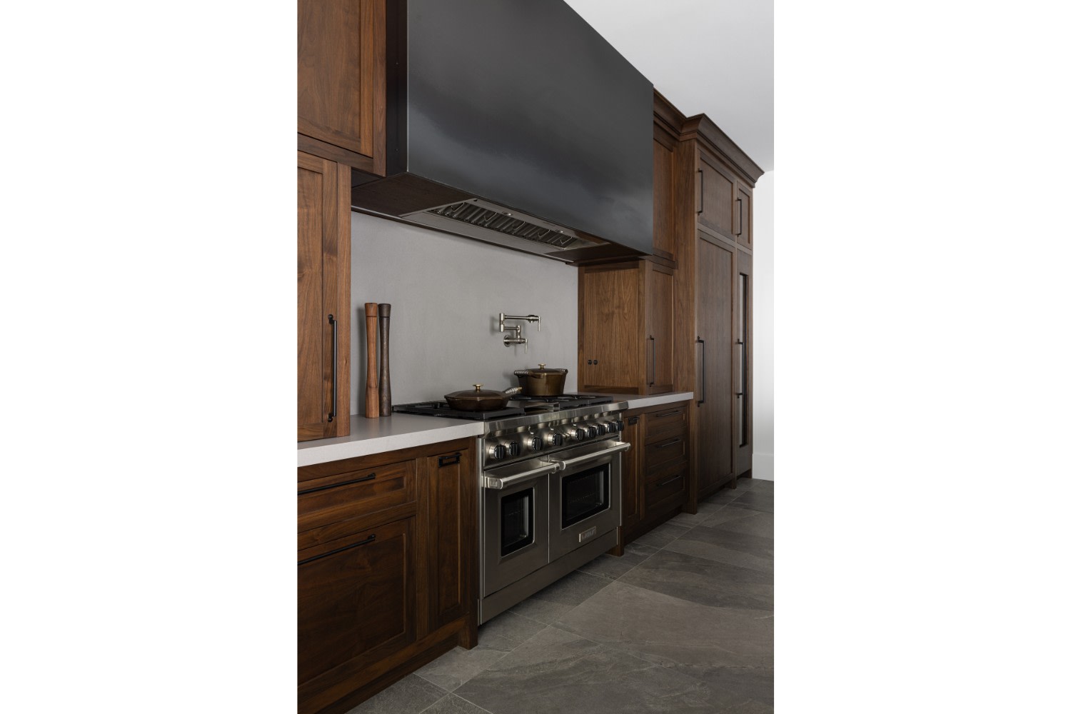 Moody contemporary kitchen with metal rangehood