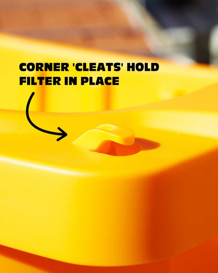 corner of tub with text 'corner cleats to hold filter in place'