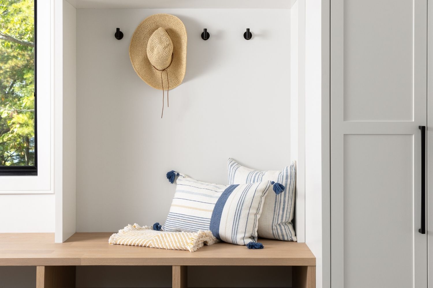 Bangor Lodge mudroom with white cabinetry and white oak bench