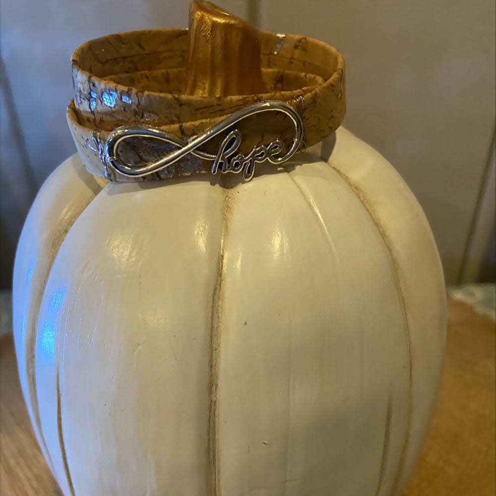 White pumpkin and bracelet reading 