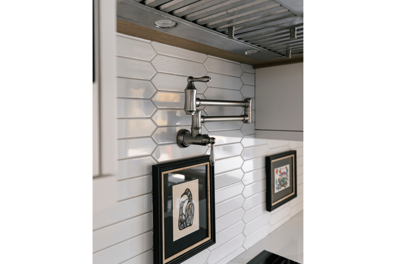 Pot filler faucet in backsplash above stove in white oak kitchen