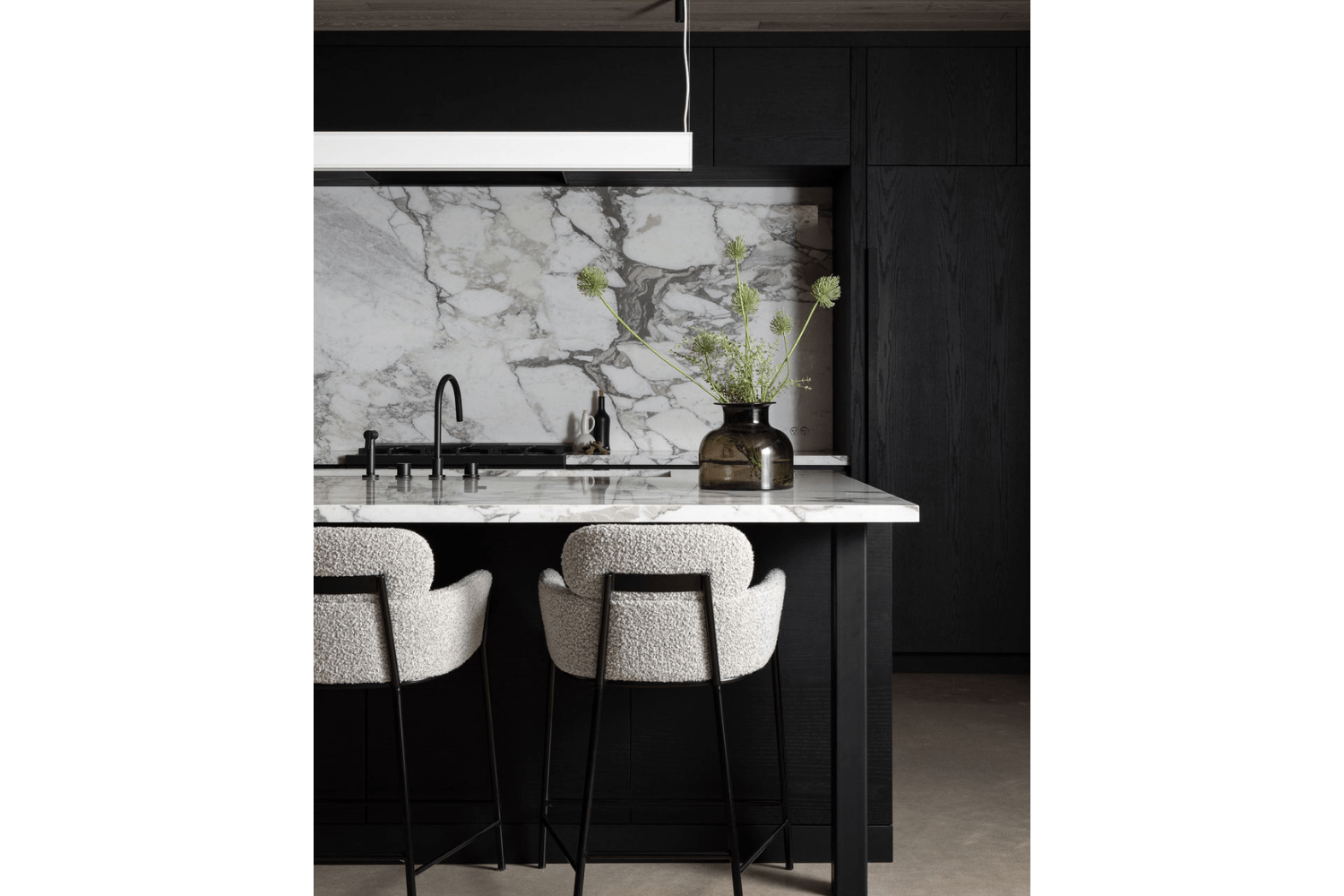 Black kitchen island with white countertop