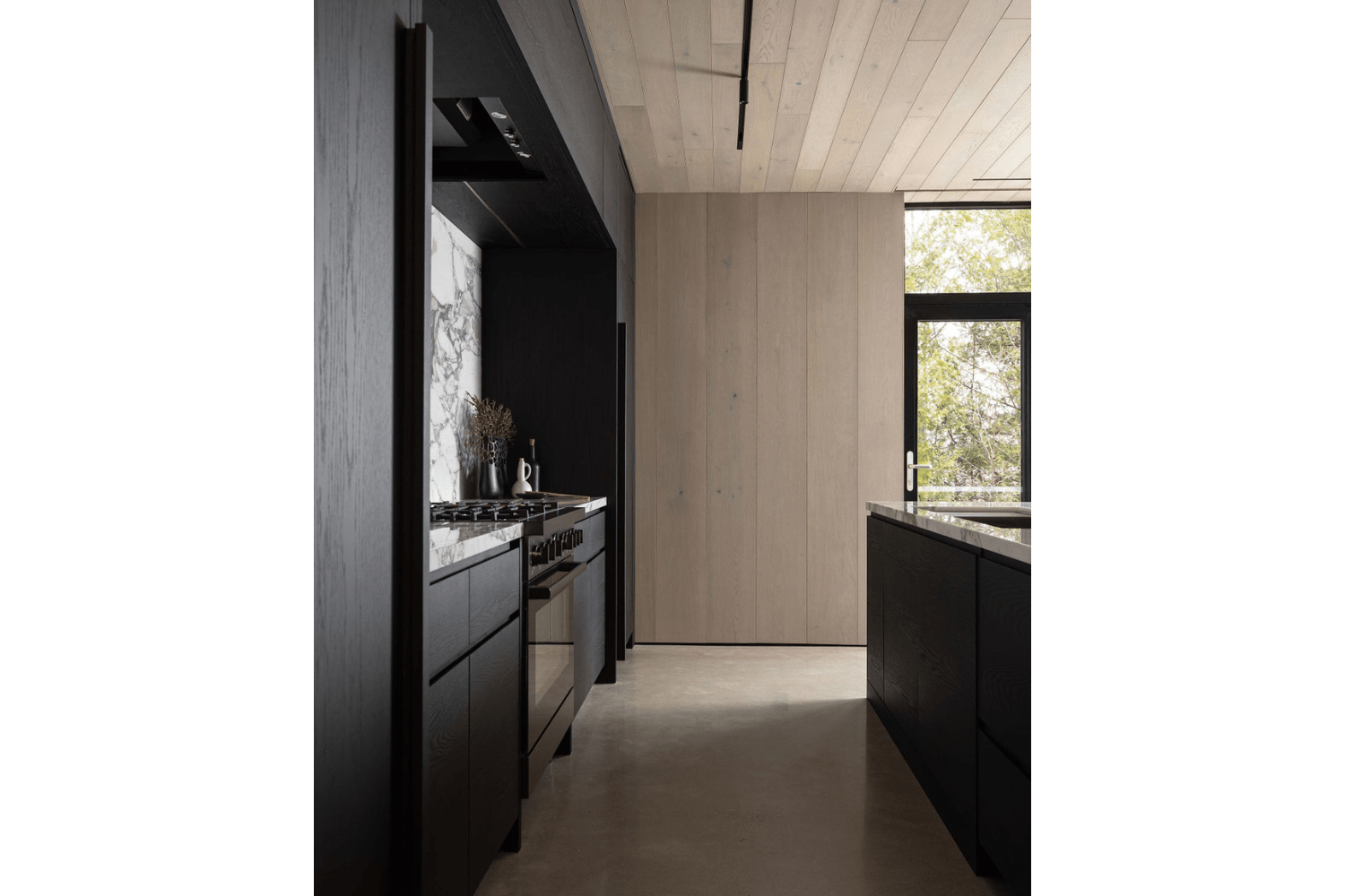 Modern industrial design with black kitchen cabinetry and cement