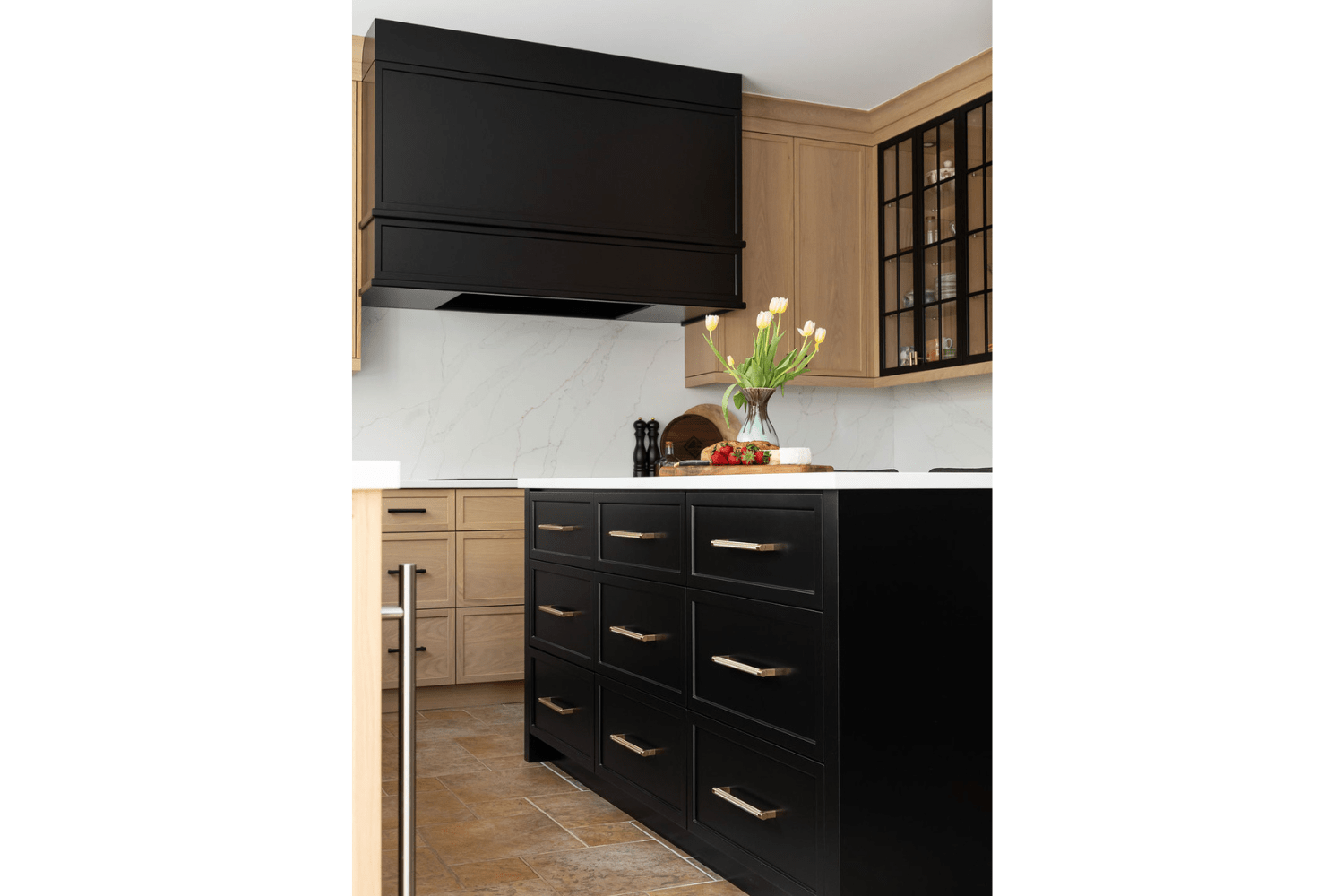 Black kitchen island with brass pulls in transitional white oak 