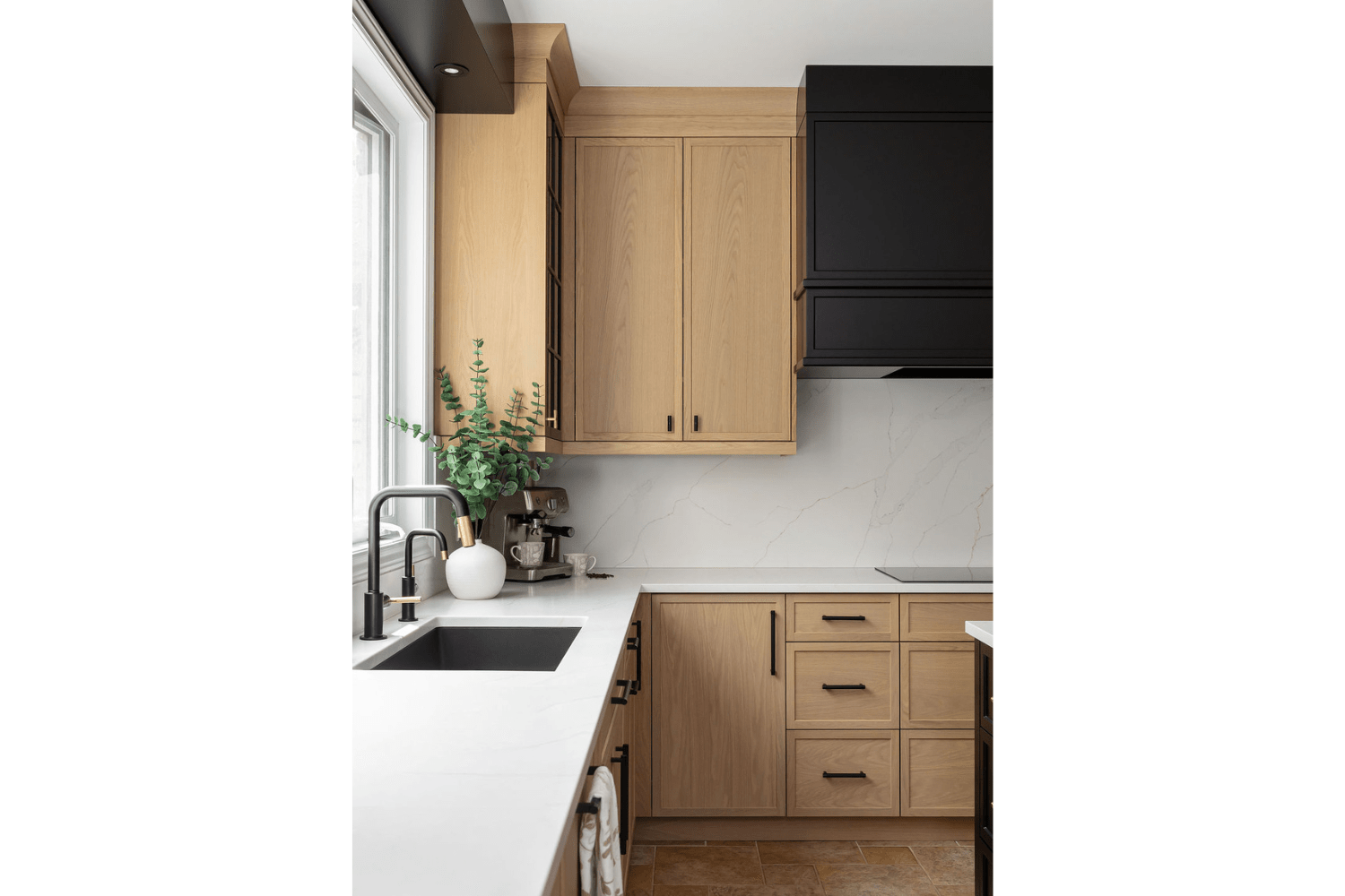White oak kitchen with crown moulding and black hardware